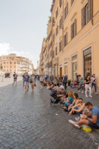 Tourists sitting on a Roman street