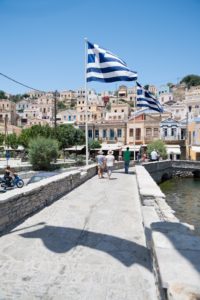 Greek flag fluttering over Symi Greece